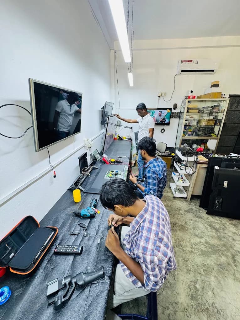 Technicians repairing TVs